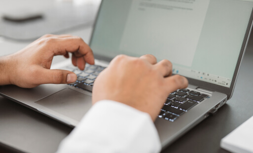Person arbeitet an einem Laptop und entwickelt digitale Lösungen.